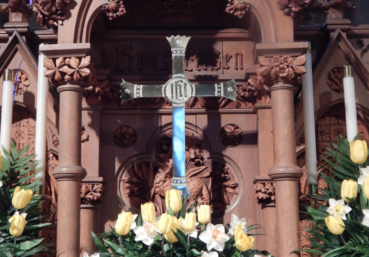 cross on altar with flowers