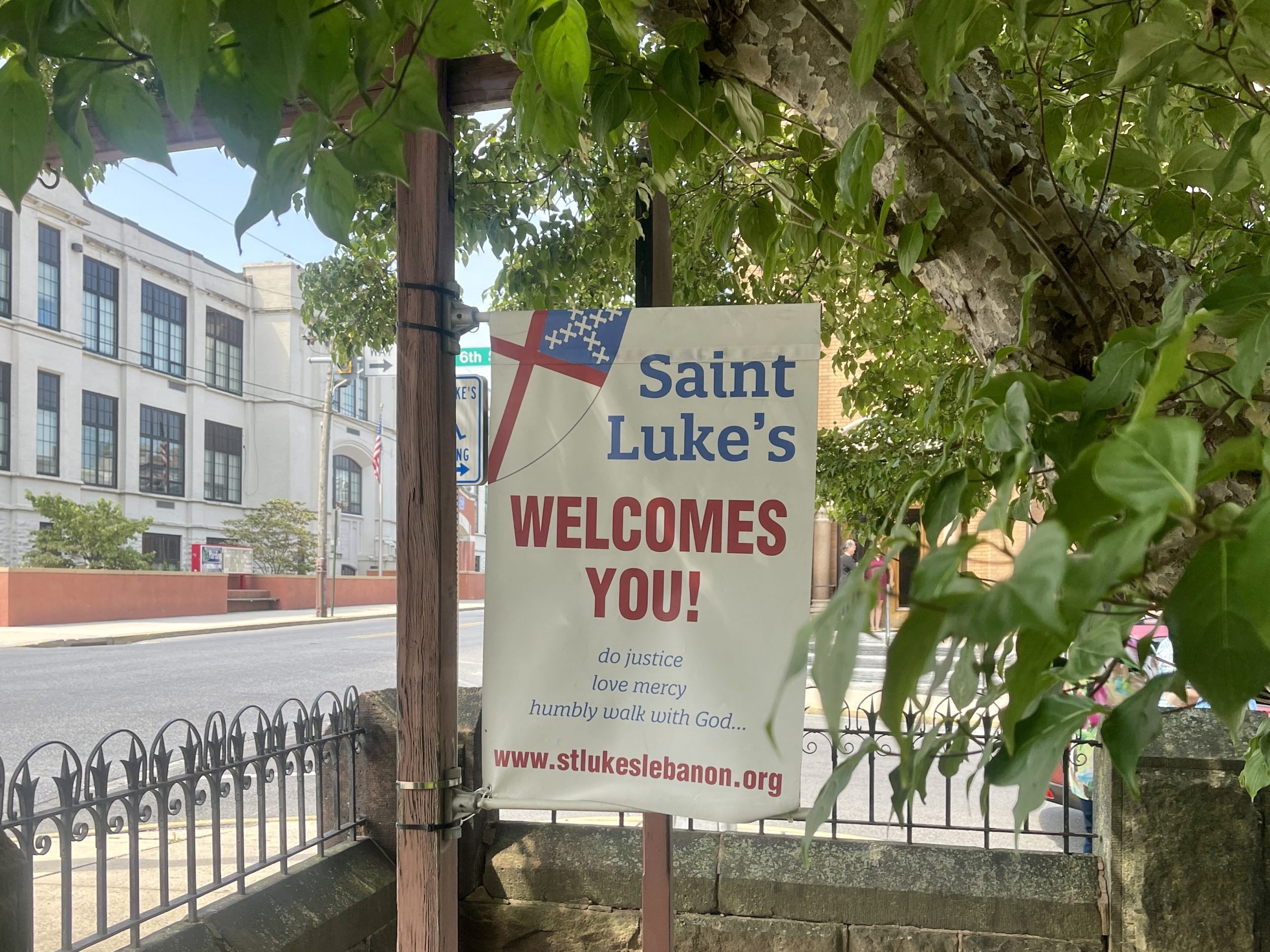 St. Luke's Welcomes You sign under tree