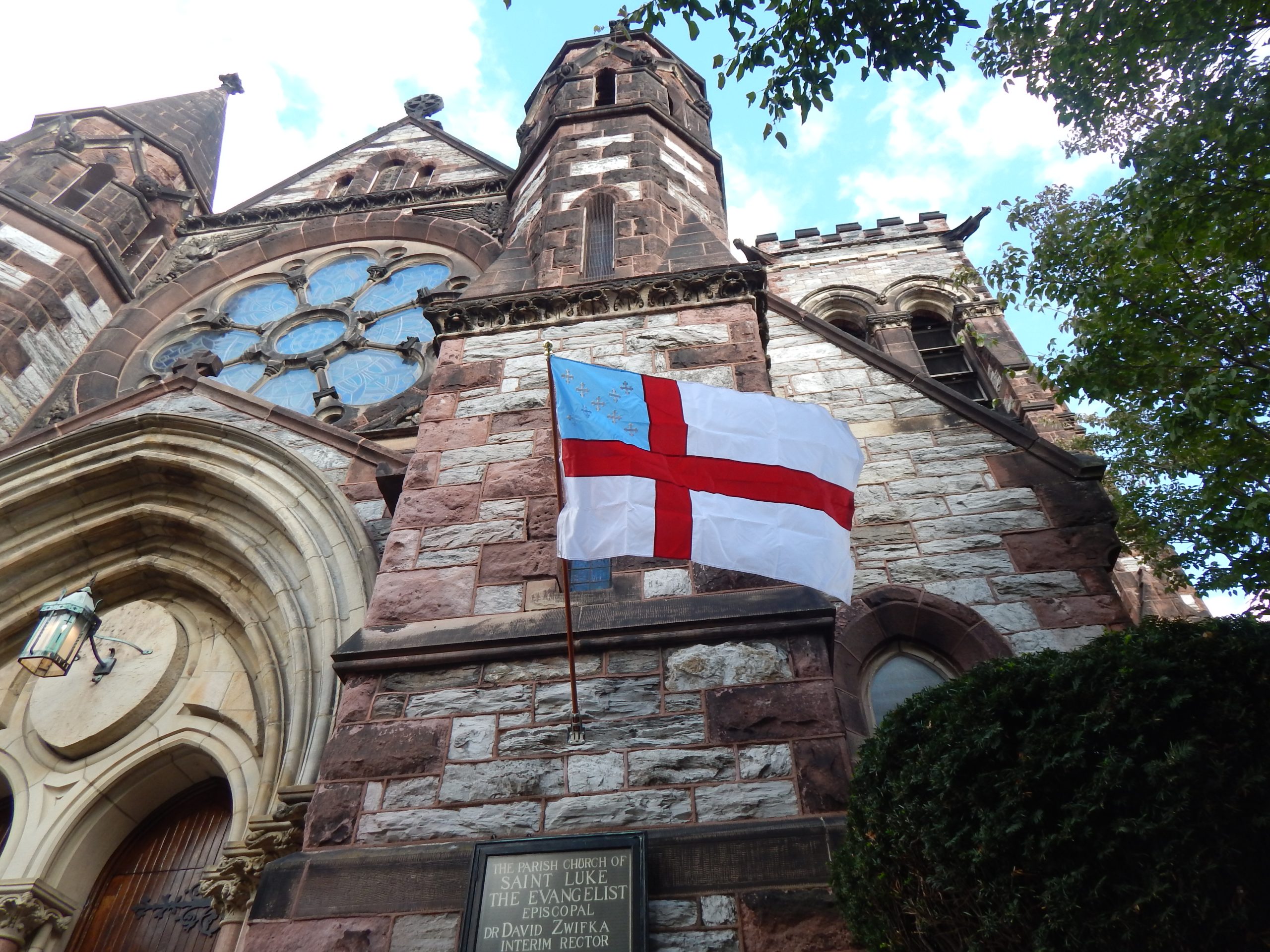 exterior of stone church with episcopal flag